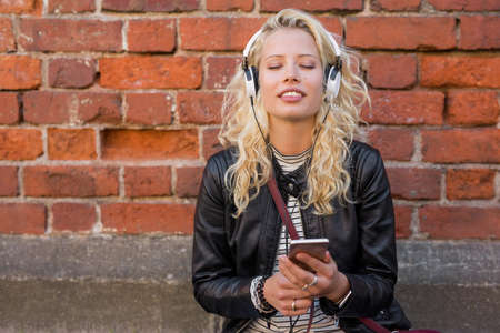Woman enjoying music on her smartphoneの写真素材