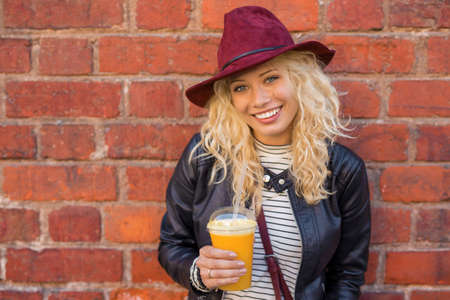 Healthy woman with cup of orange juice in her handsの写真素材