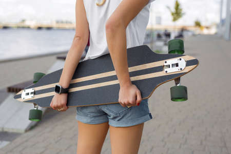 Woman holding longboardの写真素材