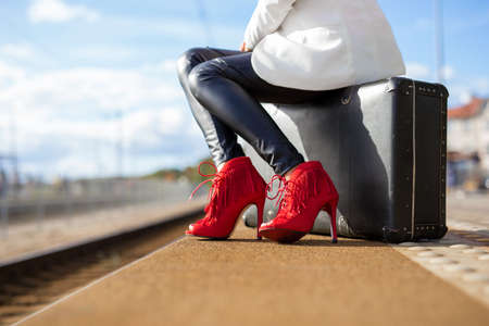 Woman in high heels at train stationの写真素材