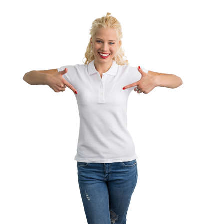 Woman in white polo T-shirt pointing at it with both handsの写真素材