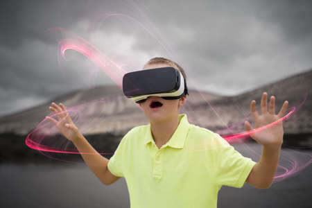 Boy enjoying virtual reality with virtual glassesの写真素材