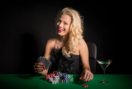 Flirty woman playing pokerの写真素材
