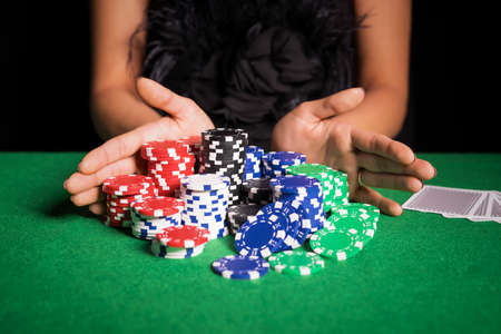 Woman playing poker with all inの写真素材