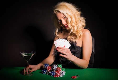 Happy and lucky woman playing pokerの写真素材