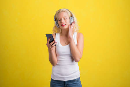 Woman listening to music on wireless headphonesの写真素材