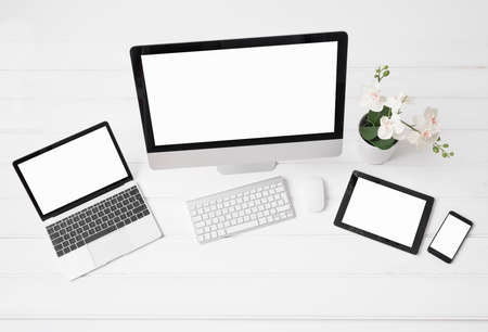 different sized screens of desktop and laptop computers tablet and phoneの写真素材