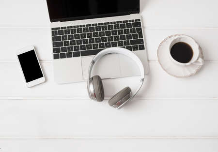 headphones laptop computer mobile phone and cup of coffeeの写真素材