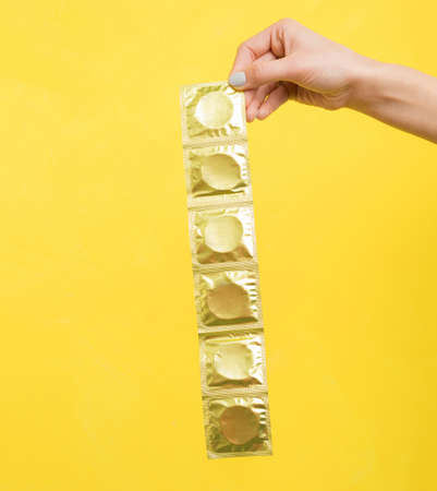 Woman holding condomsの写真素材