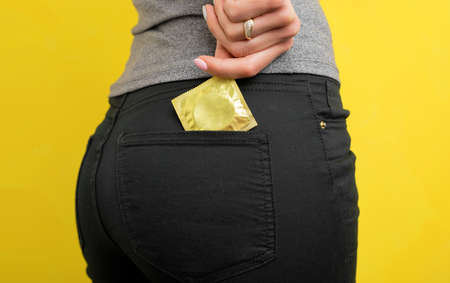 Woman putting condom in pocketの写真素材