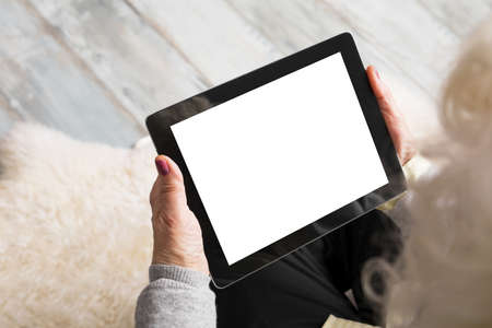 Senior holding blank screen tabletの写真素材