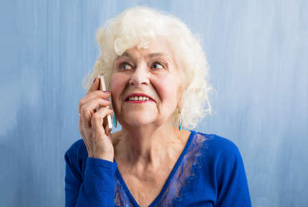 Happy grandma talking on smartphoneの写真素材