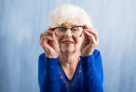Elderly woman looking through glassesの写真素材