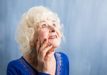 beautiful elderly woman daydreamingの写真素材