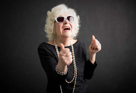 Cool grandma with her thumbs upの写真素材