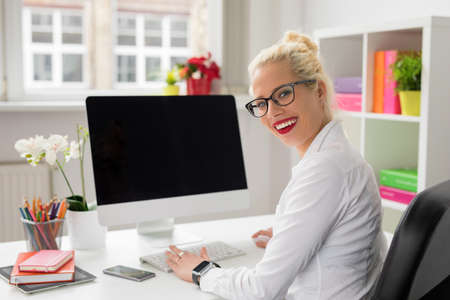 Happy corporate business woman working in officeの写真素材