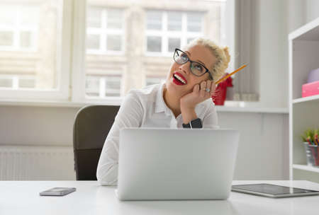 Business person in the office daydreamingの写真素材
