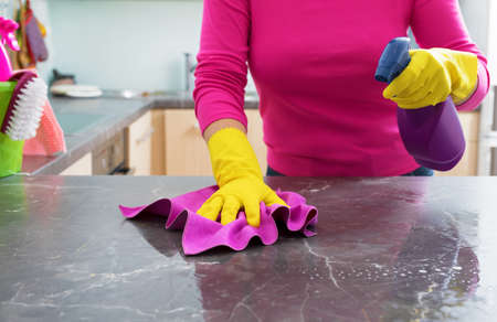 Woman cleaning kitchen counterの写真素材