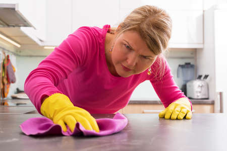 Person cleaning the hard stains from counterの写真素材