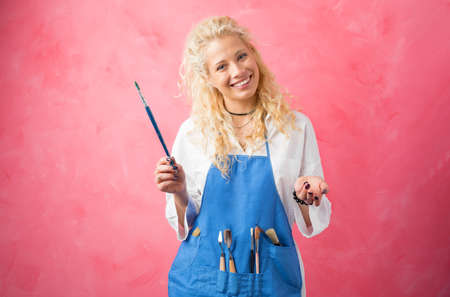 Artist/ painter with paint brush in hands smilingの写真素材