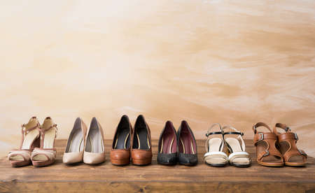 Organized woman's shoes on wooden floorの写真素材