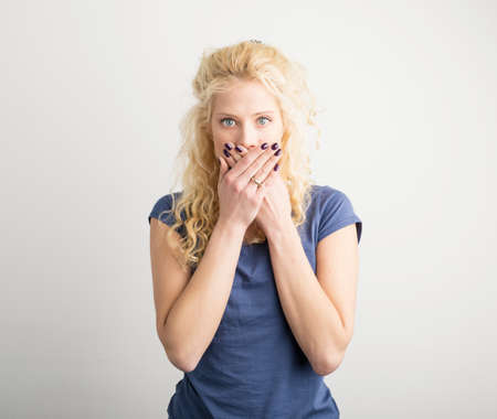 Woman covering her face with both armsの写真素材