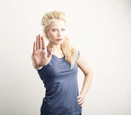 Woman showing stop sign with her handの写真素材