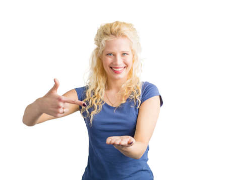 Woman pointing at invisible objet that she is holdingの写真素材