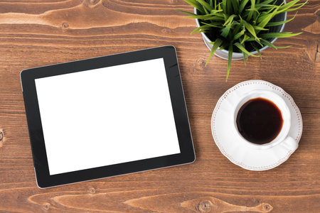 Tablet computer with blank screen and coffee