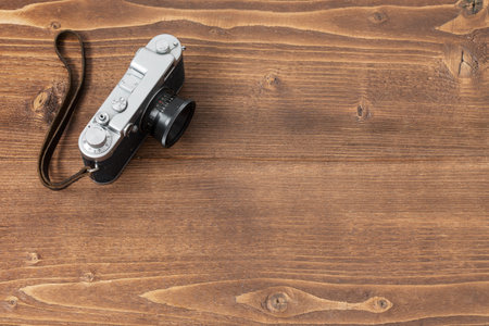 Old school camera on wooden background