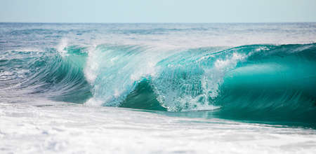 Turquoise blue rolling wavesの写真素材