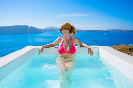 Woman relaxing in outdoor bathtubの写真素材