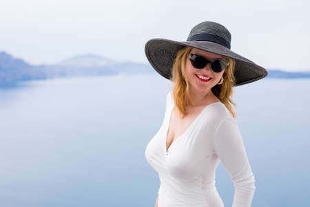 Woman in white dress and black hatの写真素材
