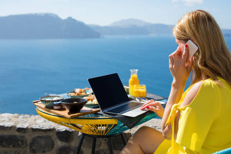 Woman working while on vacation in Mediterraneanの写真素材