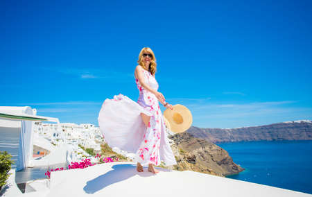 Woman tourist enjoying beautiful Santoriniの写真素材