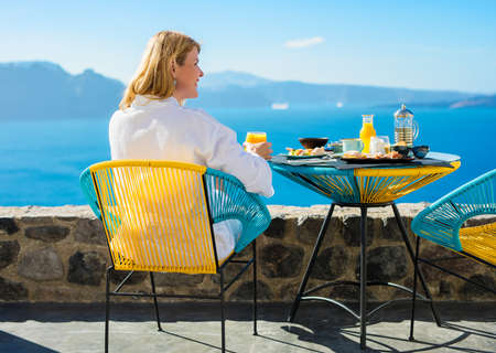 Woman enjoying summer morning on terraceの写真素材