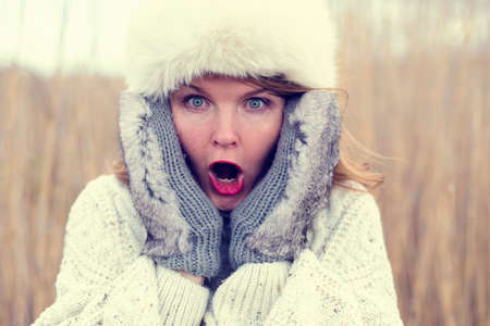 Woman in shock wearing hat and glovesの写真素材