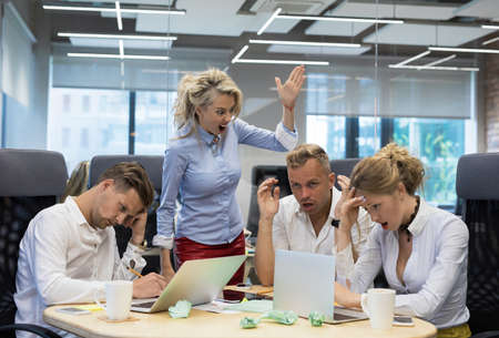Boss screaming at employeesの写真素材