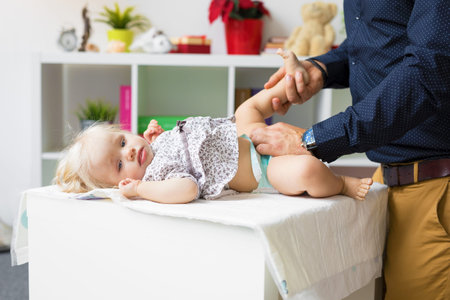 Father changing diapers