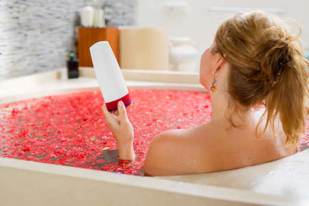 Woman holding bathing product in handの写真素材
