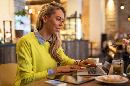 Woman working with laptop in cafeの写真素材