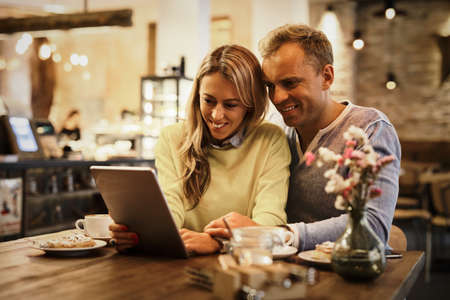 Couple looking at tablet computer togetherの写真素材