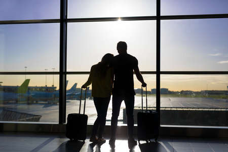 Couple waiting for flight in airportの写真素材