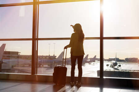 Woman waiting for her flight in airportの写真素材