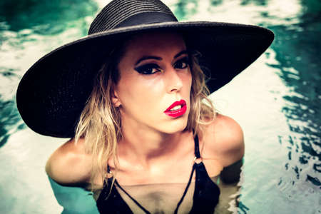 Fashion model posing in the poolの写真素材