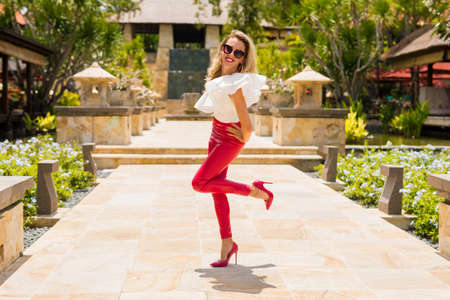 Attractive woman in red leather pants and high heelsの写真素材
