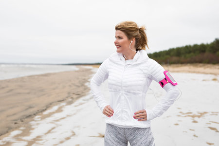 Fitness woman before winter workout on the beach