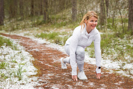 Woman preparing for a run outdoors in winterの写真素材
