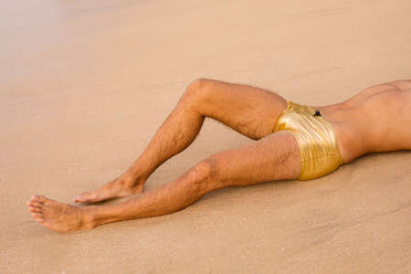 Man in sexy trunks on the beachの写真素材