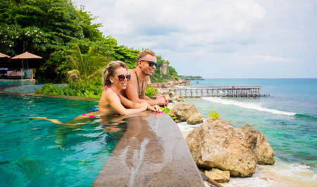 Couple relaxing in tropical swimming poolの写真素材